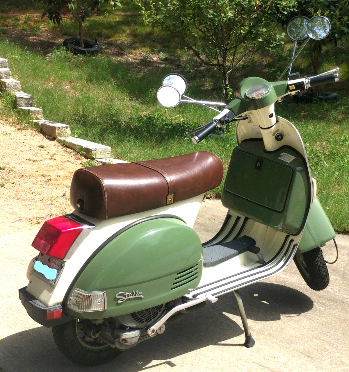 Rear view of a green and cream Genuine Stella fitted with a whiskey-brown seat cover handmade by Cheeky Seats