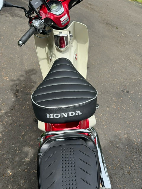 Honda Super Cub black tuck and roll seat cover installed