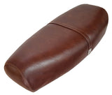Whiskey-brown Genuine Stella seat cover with tonal stitching and matching strap, handmade by Cheeky Seats