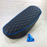 Black double-diamond Honda DAX 125 seat cover with electric blue stitching, piping and matching lock bracket, handmade by Cheeky Seats