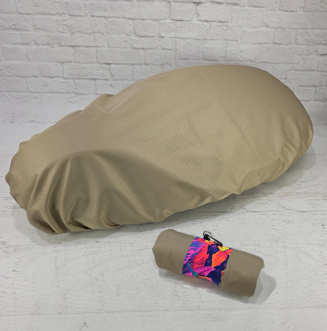 Sand honeycomb Honda DAX 125 protective seat cover with a matching pouch and tropical floral strap, by Cheeky Seats