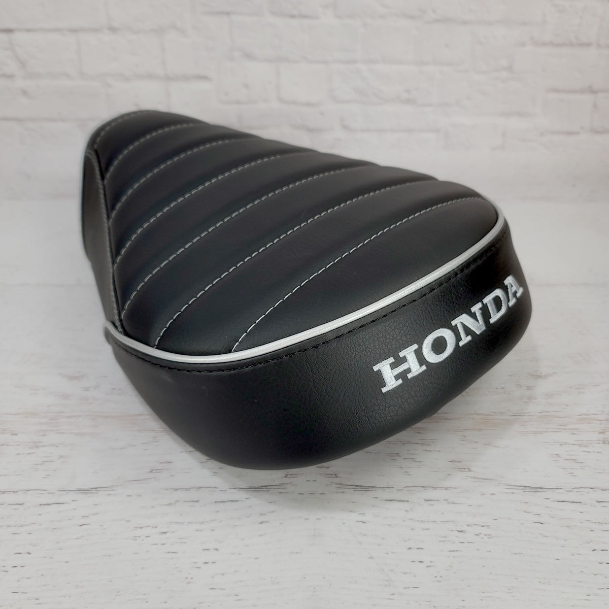 Honda Super Cub black tuck and roll seat cover by Cheeky Seats